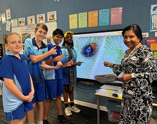 Stuart Park Primary School students and teacher pointing at a screen